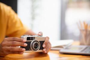 Vintage style film cameras are back in use today because film cameras are classic and have a beautiful shape that gives image unique tone causing some photographers to turn to film cameras. Copy Space photo
