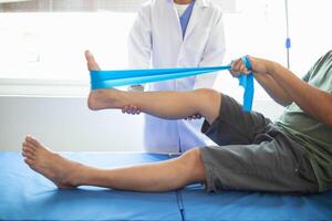 Doctors are examining patient muscle injuries and doing physical therapy for patient to move muscles so they can be used regularly because physical therapy will help strengthen muscles and blood flow. photo