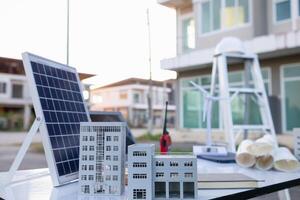 team of engineers and designers has come together to design an energy saving home or green energy home that uses natural energy such as wind turbines and solar cells to generate electricity for home. photo