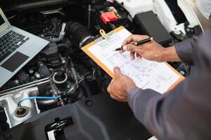car service center mechanics are checking condition car and engine make sure they are ready use and in perfect condition according center warranty. periodic vehicle inspections for safety in driving. photo