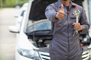 Technicians from service center inspect and assist customers cars that are having problems while traveling build confidence in customers who choose buy car from service center and receive help quickly photo