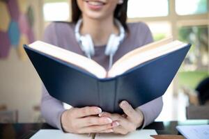 The young woman held a Bible in her hand and tried to learn and understand God teachings from the Bible she held. Concepts of belief and the power of faith in God and teachings from the Bible. photo