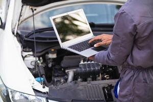 car service center mechanics are checking condition car and engine make sure they are ready use and in perfect condition according center warranty. periodic vehicle inspections for safety in driving. photo