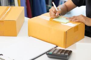 SME entrepreneurs prepare packages and verify customer information deliver products according orders. Concepts of selling online and doing online marketing with reliable system of shopping online photo
