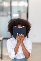 The young woman held a Bible in her hand and tried to learn and understand God teachings from the Bible she held. Concepts of belief and the power of faith in God and teachings from the Bible. photo