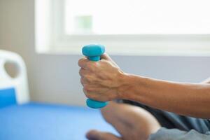 doctor is checking for muscle injuries and using dumbbells test injury and also help with physical therapy strengthen muscles because physical therapy will help strengthen muscles and help blood flow photo