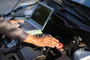 car service center mechanics are checking condition car and engine make sure they are ready use and in perfect condition according center warranty. periodic vehicle inspections for safety in driving. photo