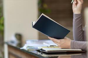 The young woman held a Bible in her hand and tried to learn and understand God teachings from the Bible she held. Concepts of belief and the power of faith in God and teachings from the Bible. photo