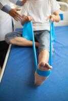 Doctors are examining patient muscle injuries and doing physical therapy for patient to move muscles so they can be used regularly because physical therapy will help strengthen muscles and blood flow. photo
