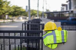 Yellow safety helmet are provided along with reflective vests for workers wear because Yellow safety helmets protect against falling objects during construction and reflective vests provide visibility photo