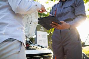 Technicians from service center inspect and assist customers cars that are having problems while traveling build confidence in customers who choose buy car from service center and receive help quickly photo