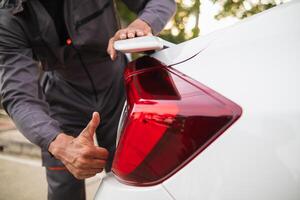 Technicians from service center inspect and assist customers cars that are having problems while traveling build confidence in customers who choose buy car from service center and receive help quickly photo