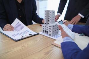 group of businessmen and investors discuss investing in real estate and jointly plan investments in construction projects of condominiums and apartments for sale and rent. investment advisory concept photo