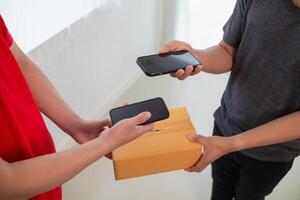SME business operator is inspecting and packing products into parcel box for delivery company that will come pick up products after participating in online marketing with Application shopping online photo