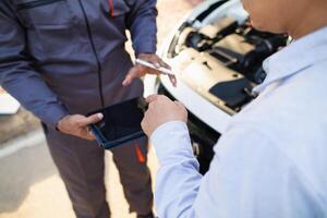 car service center mechanics are checking condition car and engine make sure they are ready use and in perfect condition according center warranty. periodic vehicle inspections for safety in driving. photo