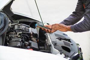 car service center mechanics are checking condition car and engine make sure they are ready use and in perfect condition according center warranty. periodic vehicle inspections for safety in driving. photo