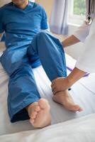Doctors are examining patient muscle injuries and doing physical therapy for patient to move muscles so they can be used regularly because physical therapy will help strengthen muscles and blood flow. photo