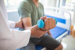 doctor is helping a patient move her muscles after recuperating from a muscle injury and wanting to rehabilitate her to be able to use her normal daily life with continuous physical therapy. photo