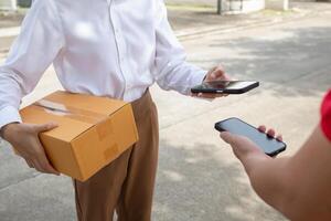 SME business operator is inspecting and packing products into parcel box for delivery company that will come pick up products after participating in online marketing with Application shopping online photo