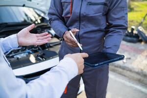 Technicians from service center inspect and assist customers cars that are having problems while traveling build confidence in customers who choose buy car from service center and receive help quickly photo