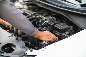 car service center mechanics are checking condition car and engine make sure they are ready use and in perfect condition according center warranty. periodic vehicle inspections for safety in driving. photo