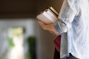 The young woman held a Bible in her hand and tried to learn and understand God teachings from the Bible she held. Concepts of belief and the power of faith in God and teachings from the Bible. photo