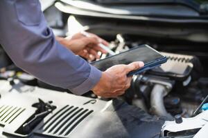 car service center mechanics are checking condition car and engine make sure they are ready use and in perfect condition according center warranty. periodic vehicle inspections for safety in driving. photo