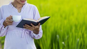 The young woman held a Bible in her hand and tried to learn and understand God teachings from the Bible she held. Concepts of belief and the power of faith in God and teachings from the Bible. photo