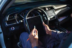Technicians from service center inspect and assist customers cars that are having problems while traveling build confidence in customers who choose buy car from service center and receive help quickly photo