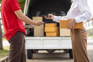 SME business operator is inspecting and packing products into parcel box for delivery company that will come pick up products after participating in online marketing with Application shopping online photo