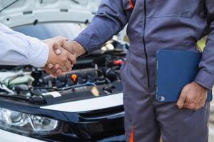 Technicians from service center inspect and assist customers cars that are having problems while traveling build confidence in customers who choose buy car from service center and receive help quickly photo