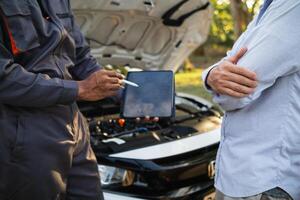 Technicians from service center inspect and assist customers cars that are having problems while traveling build confidence in customers who choose buy car from service center and receive help quickly photo
