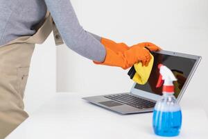 The disinfectant-based cleaning solution is prepared in a spray bottle for easy spraying to clean office interiors and furniture surfaces. Concept of contract Hire a cleaner and spraying disinfectant photo