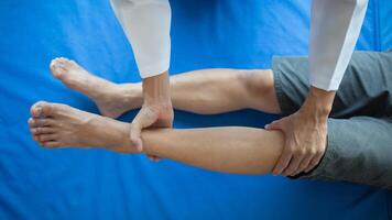 Doctors are examining patient muscle injuries and doing physical therapy for patient to move muscles so they can be used regularly because physical therapy will help strengthen muscles and blood flow. photo