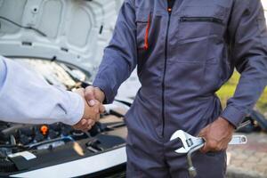 Technicians from service center inspect and assist customers cars that are having problems while traveling build confidence in customers who choose buy car from service center and receive help quickly photo