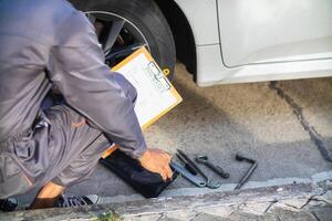 Technicians from service center inspect and assist customers cars that are having problems while traveling build confidence in customers who choose buy car from service center and receive help quickly photo