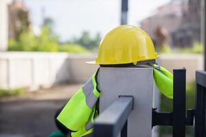 Yellow safety helmet are provided along with reflective vests for workers wear because Yellow safety helmets protect against falling objects during construction and reflective vests provide visibility photo