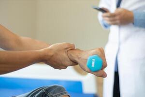 doctor is helping a patient move her muscles after recuperating from a muscle injury and wanting to rehabilitate her to be able to use her normal daily life with continuous physical therapy. photo
