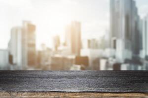 Wooden Table Top With Blurred City Background photo