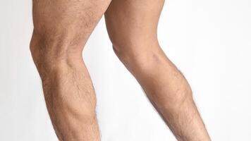 Muscular legs of a man, calves of both feet seen from the side, with a white background and space for text photo