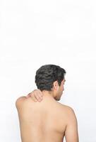 Shirtless man with neck pain showing back with white background and space for text above. photo