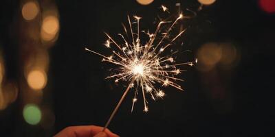 Sparkler glistens in the dark. A warm New Year's atmosphere in the dark. photo