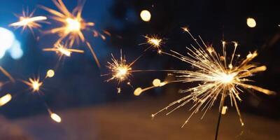 Sparkler glistens in the dark. A warm New Year's atmosphere in the dark. photo