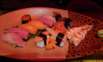 a plate of sushi with different types of fish photo