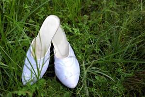 Javanese traditional bridal sandals on the grass photo