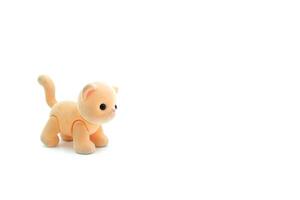 Close-up of a miniature toy cat on a white background. Copyspace can be used for your text. photo
