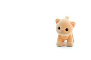 Close-up of a miniature toy cat on a white background. Copyspace can be used for your text. photo