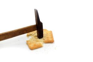 malkist crackers on a white background are hit by a hammer photo