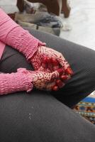 somebody wearing henna in her hand photo