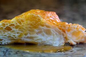 delicious appetizing cut croissant porous structure of puff pastry syrup next to two fresh strawberries on a marble table white plate close-up space for text advertising offers photo for recipe book